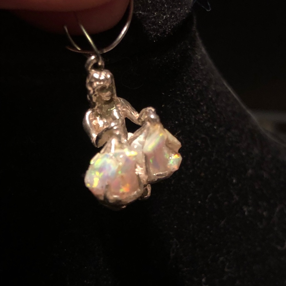 Lady holding scales with opal chips on scales